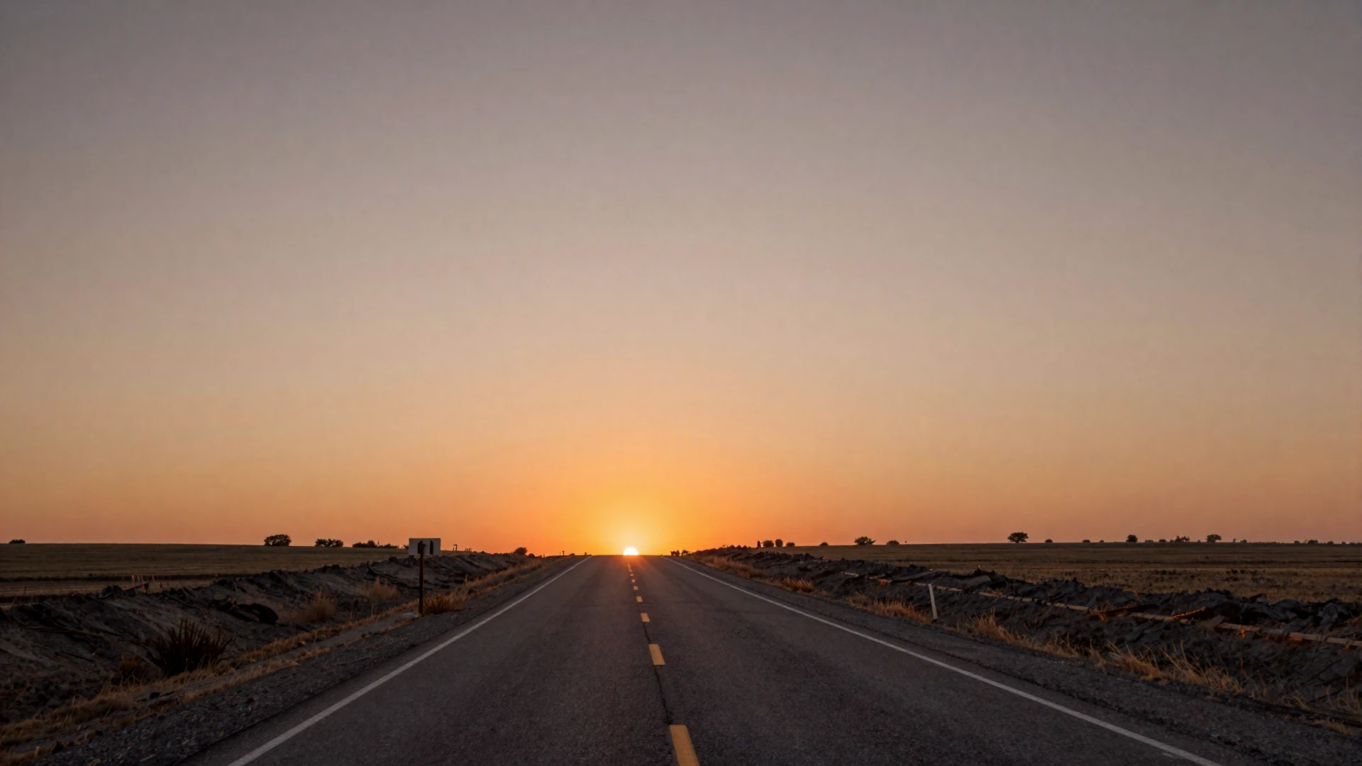 Warm sunset gradient over an open American highway representing the RouteSingles trucker dating platform