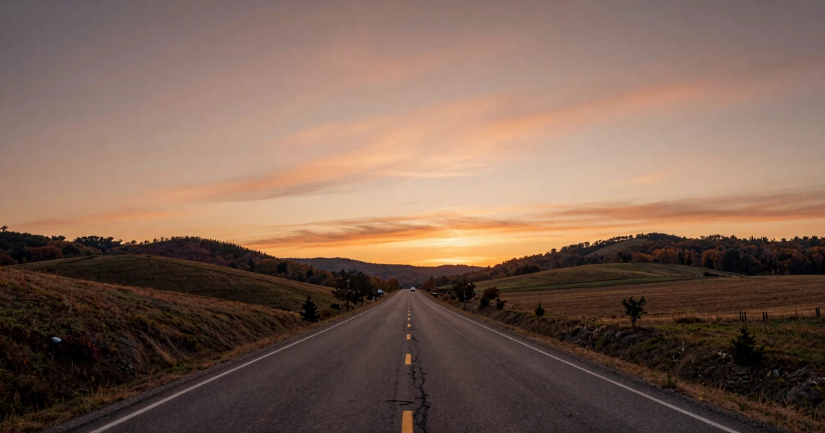 Rural Arkansas highway at sunset with warm orange sky over Ozark hills, representing trucker dating in the Natural State