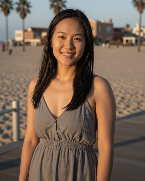 Mia, a 27-year-old Asian woman in a casual dress at Venice Beach boardwalk, seeking trucker dating in Los Angeles